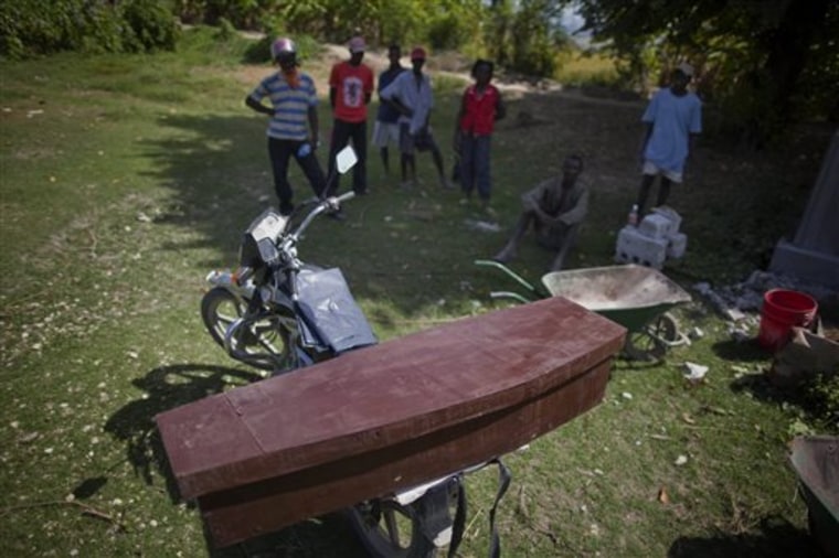 The coffin of Frist Fleurant, 10, who died of cholera, sits atop a motorcycle before his burial in Rossignol, Haiti, Sunday, Oct. 24, 2010. A spreading cholera outbreak in rural Haiti threatened to outpace aid groups as they stepped up efforts hoping to keep the disease from reaching the camps of earthquake survivors in Port-au-Prince. Health officials said at least 250 people had died and there are over 3,000 sick. (AP Photo/Ramon Espinosa)